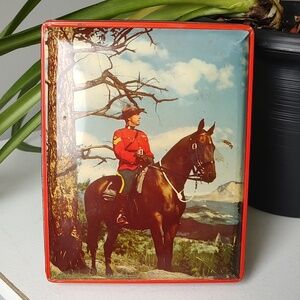 Vintage Tin Featuring A Canadian Mountie On Horseback